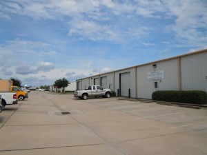 Commercial warehouse buildings with concrete parking & sidewalks
