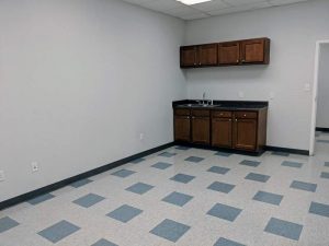 Large break room with cabinets and sink